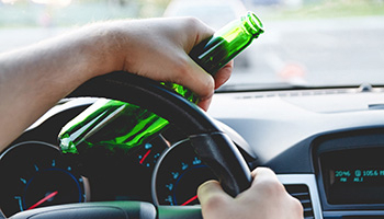 Driving with an alcohol bottle